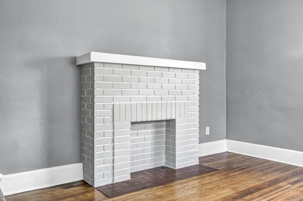 Empty room with brick fireplace